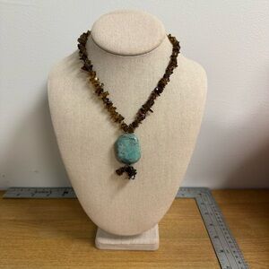 Large turquoise stone pendant with amber chip string necklace